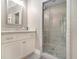 Bathroom with granite vanity and frameless glass shower with pebble floor at 2638 Clairmont Rd, Atlanta, GA 30329