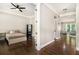 Cozy bedroom featuring dark hardwood floors, a ceiling fan, and a view into a sunny sitting area at 2638 Clairmont Rd, Atlanta, GA 30329