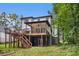 Rear exterior featuring a multi-tiered deck, connecting the home to a lush green backyard at 2638 Clairmont Rd, Atlanta, GA 30329