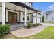 Inviting front porch with stained wood double doors, contrasting black trim, white pillars, and manicured landscaping at 2638 Clairmont Rd, Atlanta, GA 30329