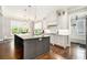 Bright kitchen features a central island with granite countertops, stainless appliances, and hardwood floors at 2638 Clairmont Rd, Atlanta, GA 30329