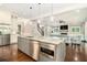 Modern kitchen with stainless steel appliances, a center island with seating, and an open view to the living room at 2638 Clairmont Rd, Atlanta, GA 30329