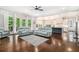 Bright living room with hardwood floors, sliding glass doors to balcony, and an open view to the kitchen at 2638 Clairmont Rd, Atlanta, GA 30329