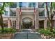 Inviting condominium building entrance with elegant stone facade and manicured landscaping at 275 13Th Ne St # 201, Atlanta, GA 30309