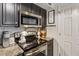 Galley kitchen features stainless steel appliances, granite countertops and dark cabinets at 275 13Th Ne St # 201, Atlanta, GA 30309