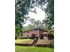 Brick home exterior with patio and stone retaining wall surrounded by lush landscaping at 406 S Hillcrest Sw Dr, Marietta, GA 30064