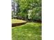 Spacious backyard with retaining wall and mature trees at 406 S Hillcrest Sw Dr, Marietta, GA 30064