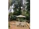 Patio features a table with chairs, a swing set, and gravel ground at 406 S Hillcrest Sw Dr, Marietta, GA 30064