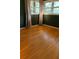 Bright bedroom with hardwood floors, neutral green walls, and natural light from the windows at 406 S Hillcrest Sw Dr, Marietta, GA 30064