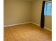 Neutral bedroom with a window providing natural light, tiled floors, and neutral paint at 406 S Hillcrest Sw Dr, Marietta, GA 30064