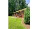 Quaint brick home with vibrant green lawn, flower-filled window boxes, and inviting entry steps at 406 S Hillcrest Sw Dr, Marietta, GA 30064