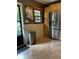 Bright kitchen with stainless steel refrigerator, wood cabinets and tile floors, leading to an outdoor area at 406 S Hillcrest Sw Dr, Marietta, GA 30064