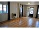 Bright living room featuring tile flooring, wood paneling, windows with dark curtains, and an open door to the exterior at 406 S Hillcrest Sw Dr, Marietta, GA 30064