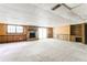 Spacious basement featuring a brick fireplace, sliding doors, and wood paneled walls at 4714 Darlene Way, Tucker, GA 30084