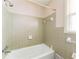 Tiled bathtub and shower featuring neutral tiled walls at 4714 Darlene Way, Tucker, GA 30084