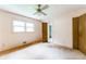 Bedroom with neutral walls and carpet, featuring windows and a ceiling fan at 4714 Darlene Way, Tucker, GA 30084