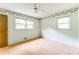 Bedroom with floral trim, light-green walls, carpet, and two windows at 4714 Darlene Way, Tucker, GA 30084