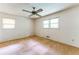 Sunny bedroom with neutral carpet, a ceiling fan, and two windows at 4714 Darlene Way, Tucker, GA 30084