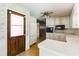 Cozy kitchen featuring white cabinets, appliances, and access to dining area at 4714 Darlene Way, Tucker, GA 30084