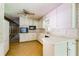 Bright kitchen featuring white cabinets, appliances, and checkered flooring at 4714 Darlene Way, Tucker, GA 30084
