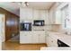 Well-lit kitchen with white cabinets and appliances, adjacent to breakfast area at 4714 Darlene Way, Tucker, GA 30084