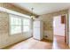 Bright kitchen space featuring a vintage light fixture and large windows overlooking a wooded lot at 4714 Darlene Way, Tucker, GA 30084