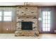 Classic living room showcasing a brick fireplace and wood-paneled walls at 4714 Darlene Way, Tucker, GA 30084
