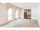 Bright living room with two windows and neutral carpet and walls at 4714 Darlene Way, Tucker, GA 30084