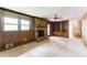 Spacious living room with wood paneling, brick fireplace, and built-in shelving at 4714 Darlene Way, Tucker, GA 30084