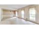 Large living room featuring many windows, a chandelier, and neutral carpet at 4714 Darlene Way, Tucker, GA 30084
