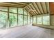 Enclosed sunroom with multiple windows providing natural light and views of the surrounding greenery at 4714 Darlene Way, Tucker, GA 30084