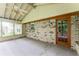 Sunroom with ample natural light, featuring exposed brick and multiple windows at 4714 Darlene Way, Tucker, GA 30084