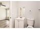 Bathroom featuring a single sink vanity and toilet at 7127 Greenway Sw Cv, Covington, GA 30014