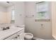 Bathroom featuring a single sink vanity, toilet, and combination shower and tub at 7127 Greenway Sw Cv, Covington, GA 30014