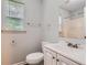 Bathroom featuring a single sink vanity, toilet, and combination shower and tub at 7127 Greenway Sw Cv, Covington, GA 30014