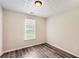 Cozy bedroom featuring wood-look flooring and one window at 7127 Greenway Sw Cv, Covington, GA 30014