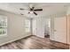 Bedroom featuring wood-look flooring, with windows and doors to bathroom and closet space at 7127 Greenway Sw Cv, Covington, GA 30014