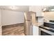 Kitchen showcasing stainless steel refrigerator, granite countertops, and modern appliances at 7127 Greenway Sw Cv, Covington, GA 30014