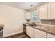 Well-lit kitchen showcasing granite countertops and sleek stainless steel appliances at 7127 Greenway Sw Cv, Covington, GA 30014