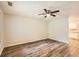 Bright living room features stylish flooring, a ceiling fan, and a view into the kitchen at 7127 Greenway Sw Cv, Covington, GA 30014