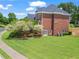Brick home with a large backyard, lush landscaping, and patio at 1000 Gunter Ct, Alpharetta, GA 30022