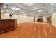 Spacious basement area featuring hardwood floors, ceiling beams, and a large entertainment area at 1000 Gunter Ct, Alpharetta, GA 30022