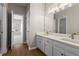 Bright bathroom features a double vanity with white cabinets and modern fixtures, plus a glass-enclosed shower at 1000 Gunter Ct, Alpharetta, GA 30022