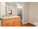 Well lit bathroom with granite countertop and a glass enclosed shower at 1000 Gunter Ct, Alpharetta, GA 30022