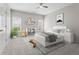 Light filled bedroom with grey carpet, white trim, ceiling fan, shelves, a bed, and decorations at 1000 Gunter Ct, Alpharetta, GA 30022