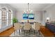 Dining room with ample natural light, modern chandelier and beautiful artwork at 1000 Gunter Ct, Alpharetta, GA 30022