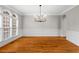 Formal dining room with hardwood floors, wainscoting and large windows at 1000 Gunter Ct, Alpharetta, GA 30022