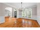 Bright dining room boasts hardwood floors, wainscoting and modern chandelier lighting at 1000 Gunter Ct, Alpharetta, GA 30022