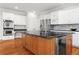 The kitchen features an island with a granite countertop and modern stainless steel appliances at 1000 Gunter Ct, Alpharetta, GA 30022