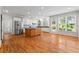 Open kitchen with an island, stainless steel appliances, and hardwood floors at 1000 Gunter Ct, Alpharetta, GA 30022